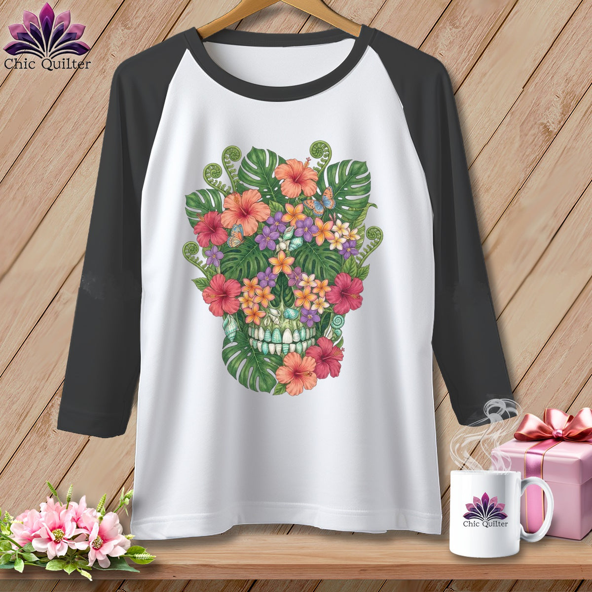 White baseball tee with a colorful floral skull graphic and dark gray sleeves.