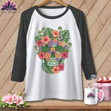 White baseball tee with a colorful floral skull graphic and dark gray sleeves.