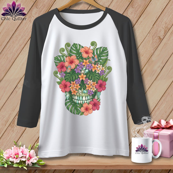 White baseball tee with a colorful floral skull graphic and dark gray sleeves.