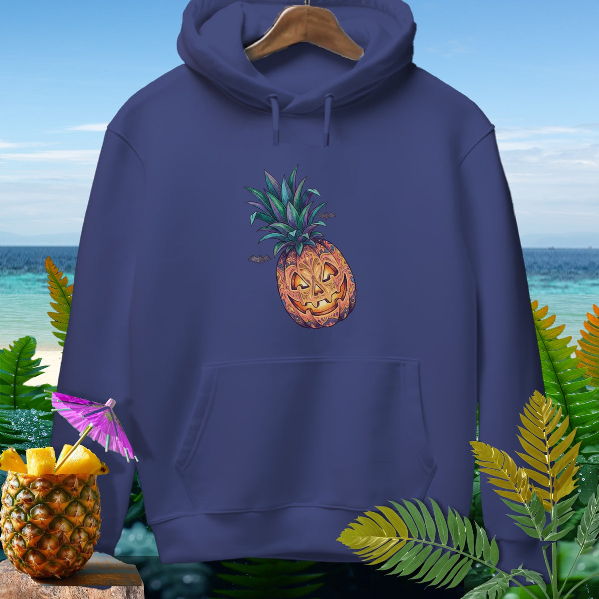 Navy hoodie with a jack-o'-lantern pineapple graphic and tropical foliage.