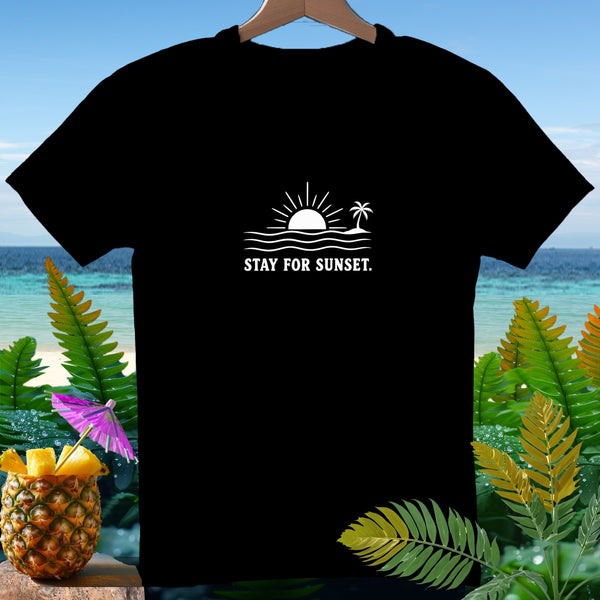 Black t-shirt with white graphic of sun, waves, palm tree, and text "STAY FOR SUNSET."