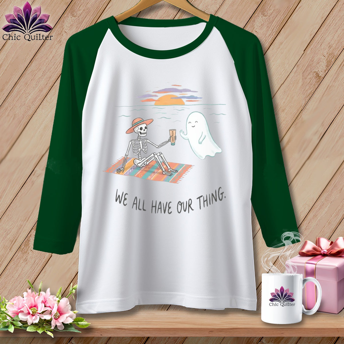 T-shirt with skeleton and ghost on beach, text reads "We all have our thing."