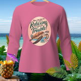 Pink long-sleeve shirt with a graphic of a turtle and text about relaxing.