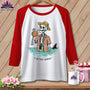 White t-shirt with red sleeves featuring a skeleton in a Hawaiian shirt drinking from a coconut, with a shark fin.