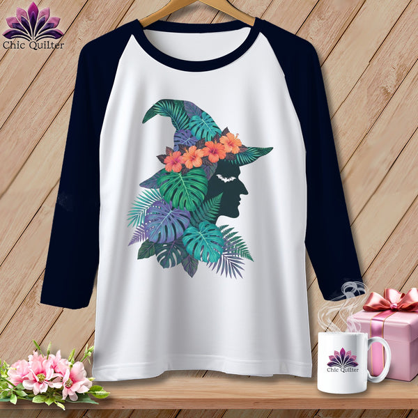 Baseball tee with witch hat graphic made of tropical leaves and flowers.