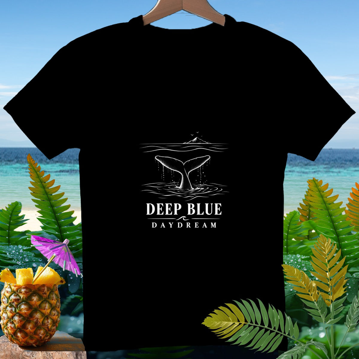 Black t-shirt with a whale tail graphic and "DEEP BLUE DAYDREAM" text.