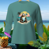 Teal long sleeve shirt with a graphic of a sloth on a beach with palm trees and a sunset.