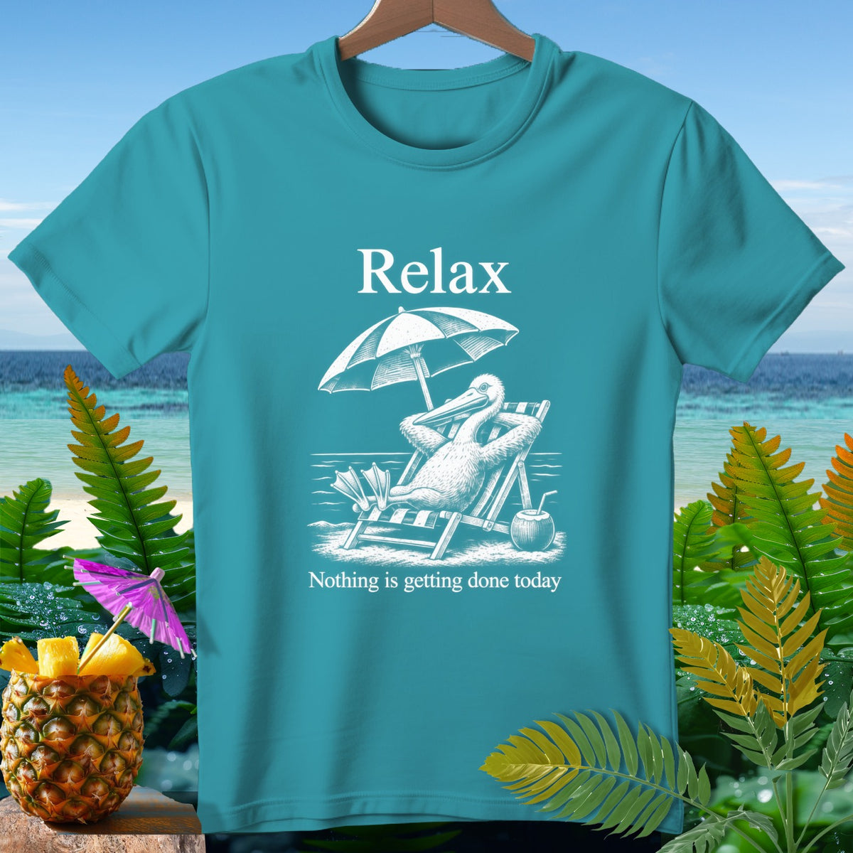 Teal t-shirt with "Relax" and a pelican on a lounge chair.