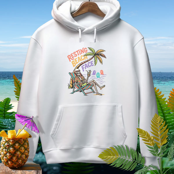 White hoodie with skeleton relaxing on a beach chair with "Resting Beach Face" text.