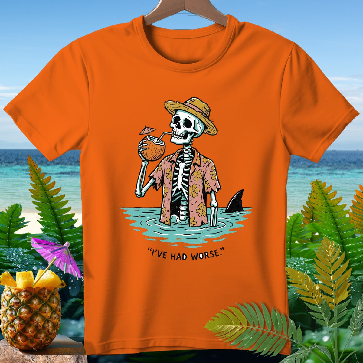 Skeleton in Hawaiian shirt drinks coconut, shark fin visible, "I've Had Worse" text.
