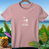 Pink t-shirt with white palm tree, sun, and ocean graphic, text 