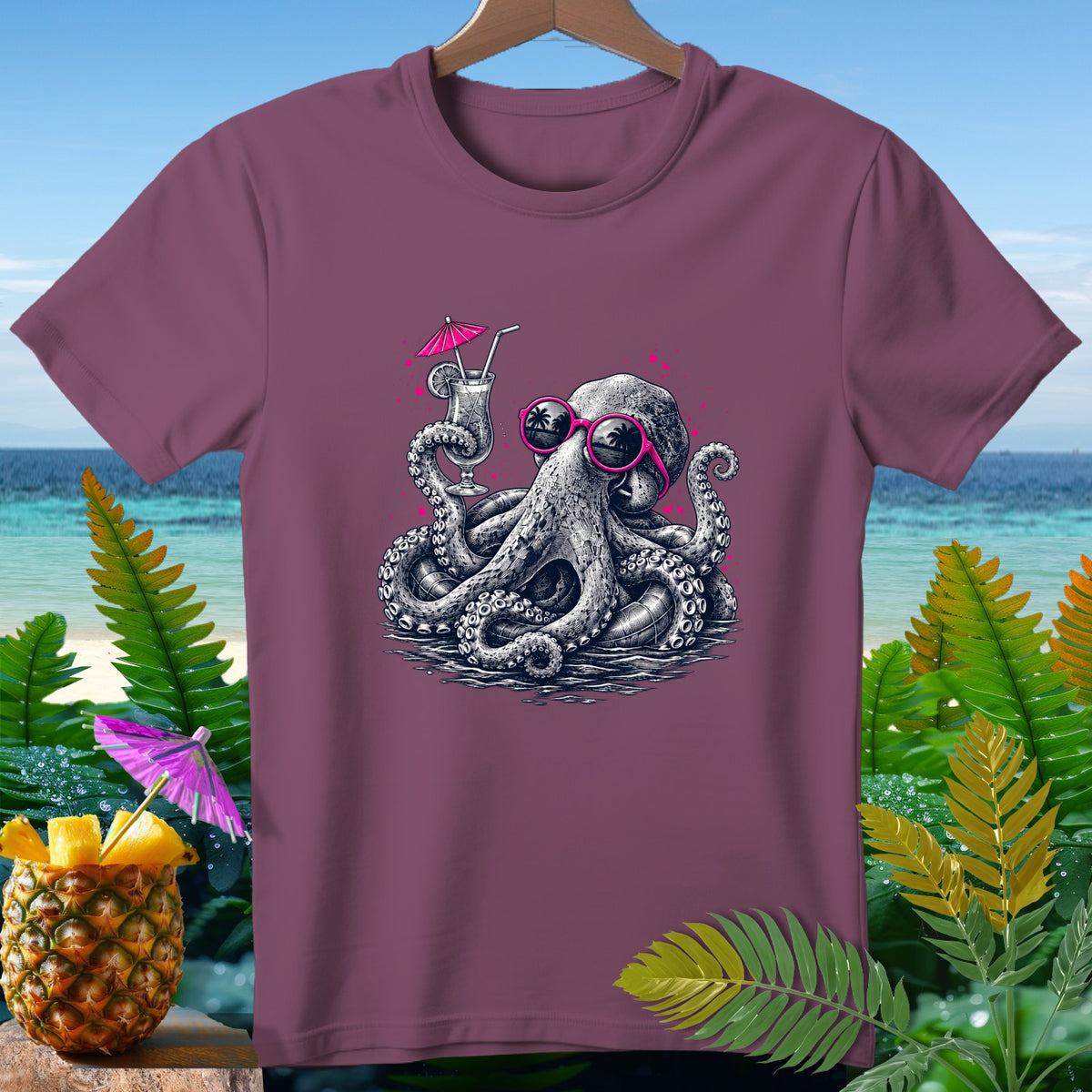 T-shirt with octopus wearing sunglasses holding a cocktail, with pineapple and beach background.