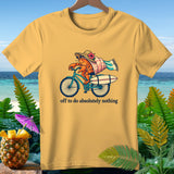 Yellow t-shirt with a hermit crab riding a bicycle, text reads 