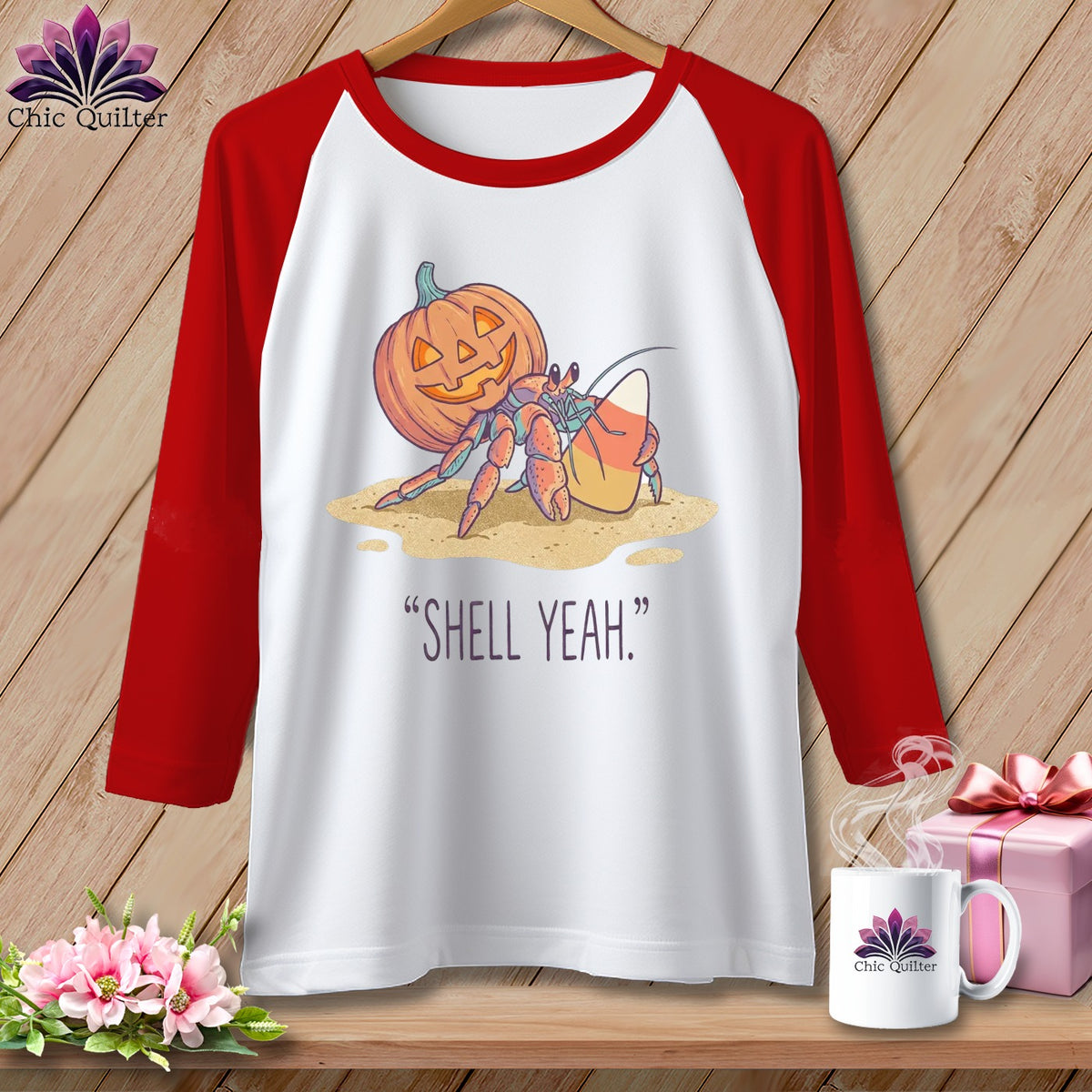 White and red baseball tee with hermit crab, pumpkin, and candy corn graphic and "Shell Yeah." text.