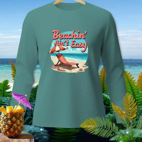 Teal long sleeve shirt with "Beachin' Ain't Easy" beach scene graphic.