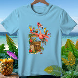 Light blue t-shirt graphic of a flamingo at a tiki bar with tropical drinks and a frog.