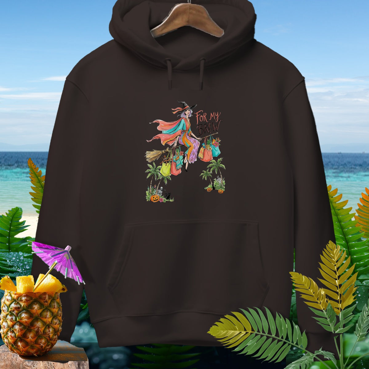 Brown hoodie with witch graphic saying "For My Brew" and tropical accents.