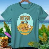 Teal t-shirt with cartoon Halloween beach scene and text 