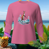 Pink long-sleeve shirt with kangaroo paddleboarding graphic and tropical foliage.