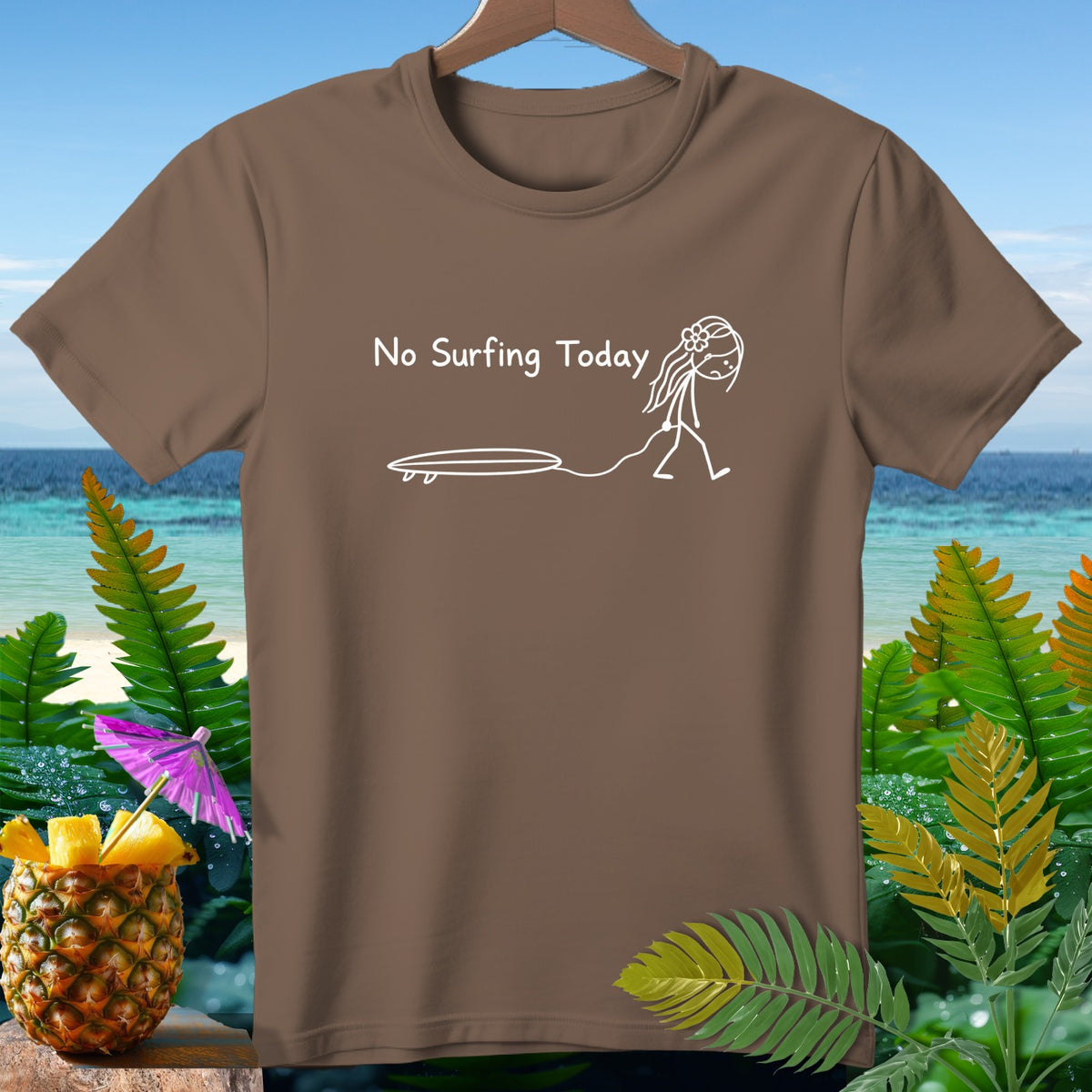 Brown t-shirt with white text "No Surfing Today" and a stick figure pulling a surfboard.