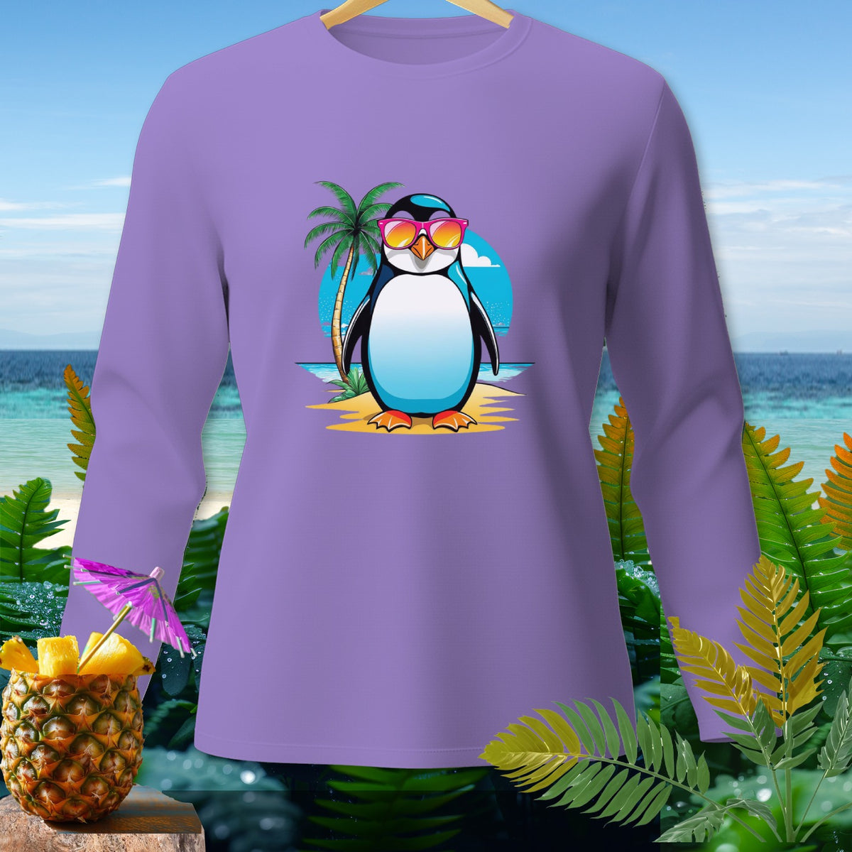 Purple long-sleeve shirt with a cartoon penguin wearing sunglasses on a beach.