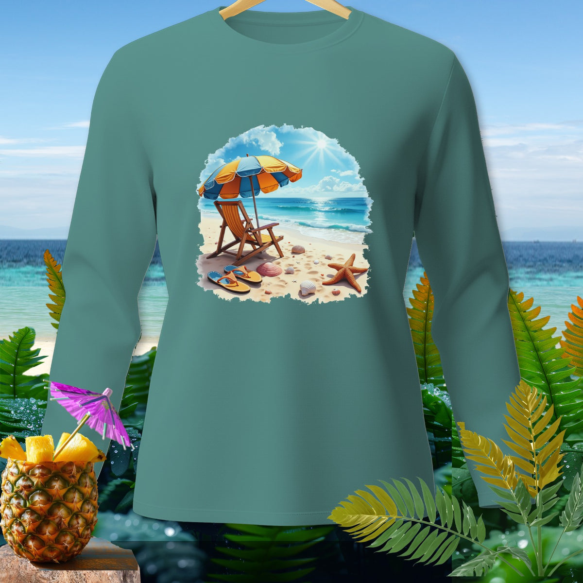 Teal long sleeve shirt with beach scene graphic featuring umbrella, chair, and seashells.