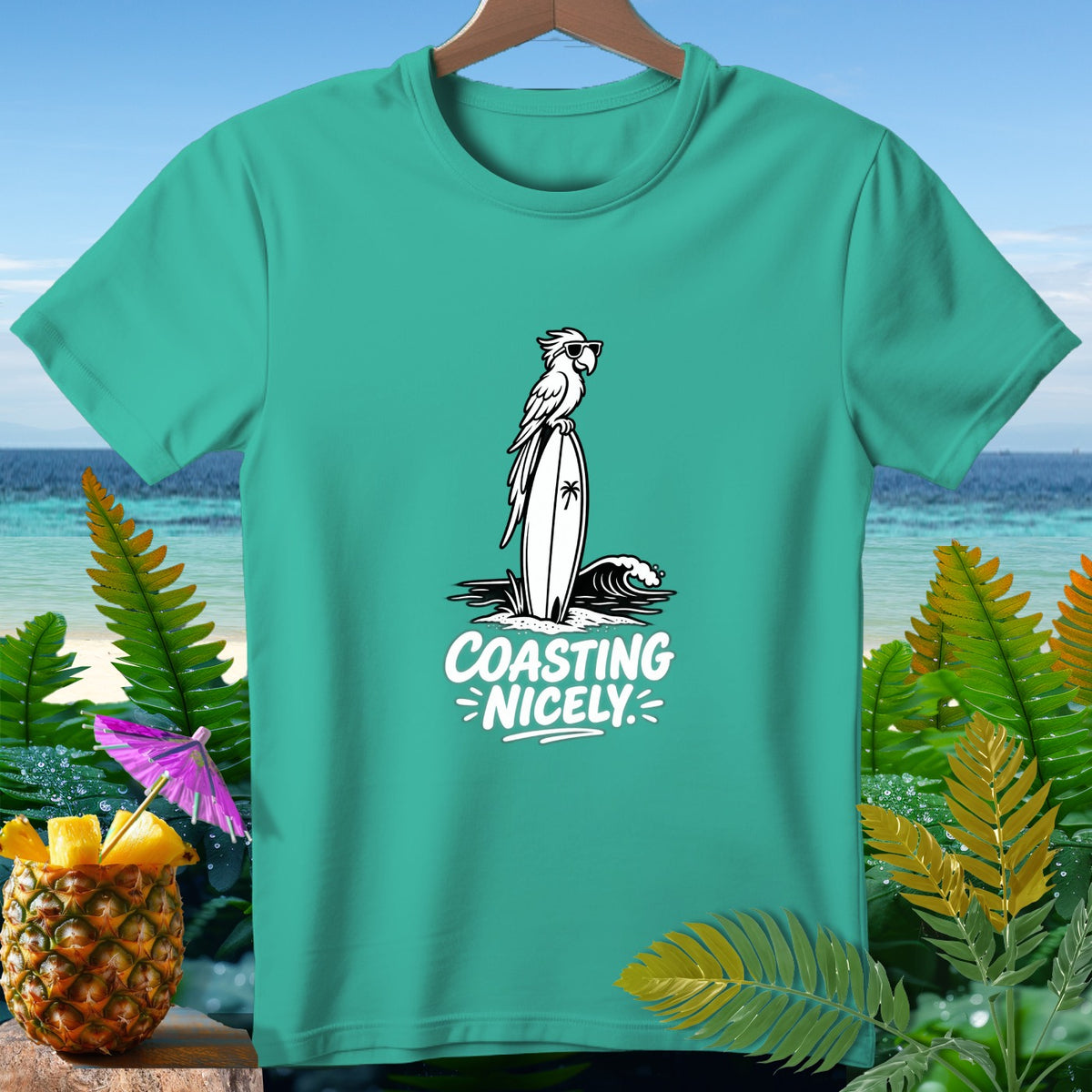 Teal t-shirt with a parrot on a surfboard and the text "COASTING NICELY".