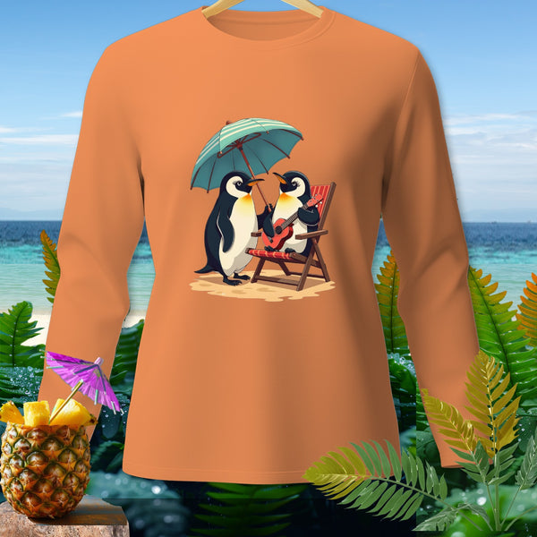 Orange long sleeve shirt with a graphic of two penguins under an umbrella on a beach.