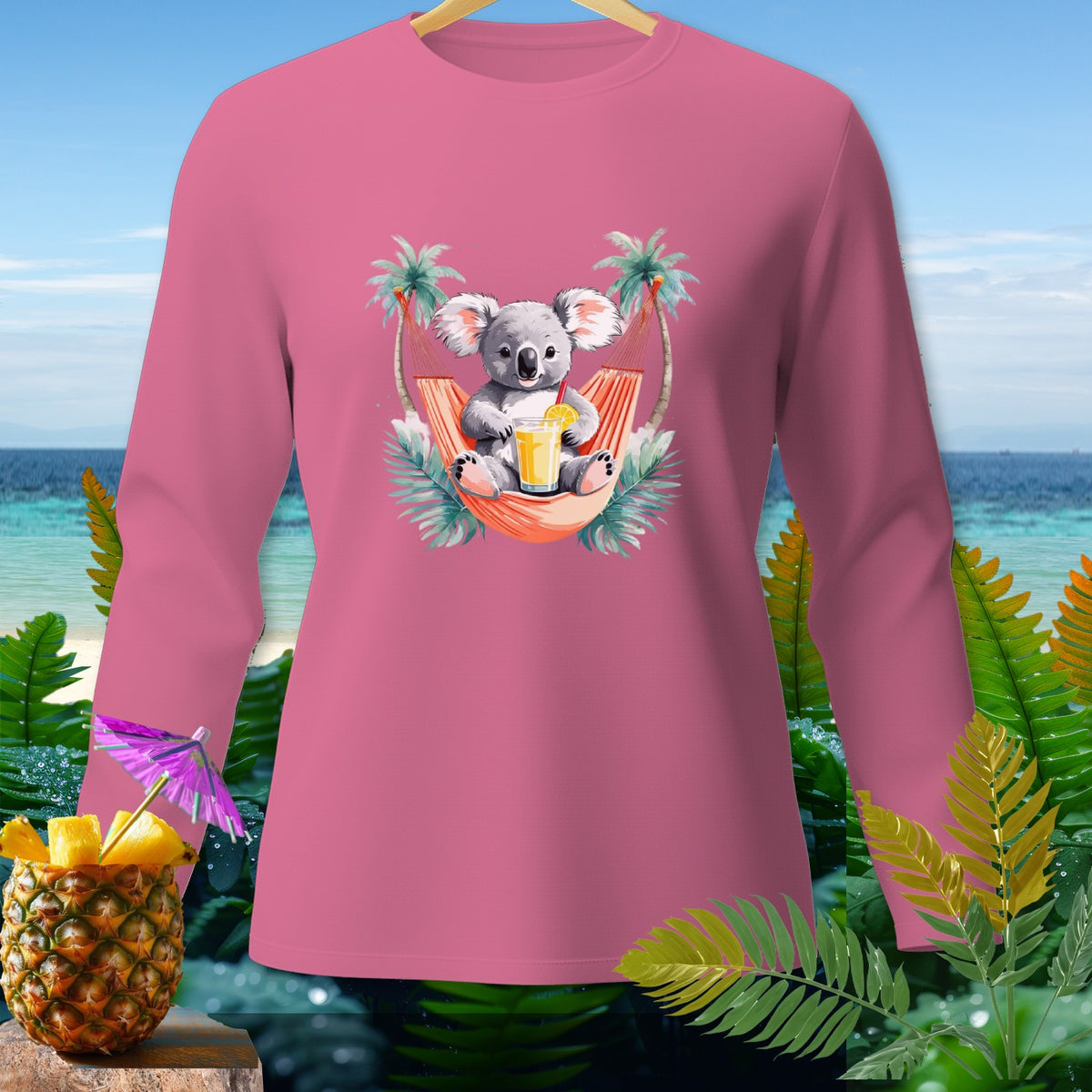 Pink long-sleeve shirt with a graphic of a koala in a hammock drinking juice.