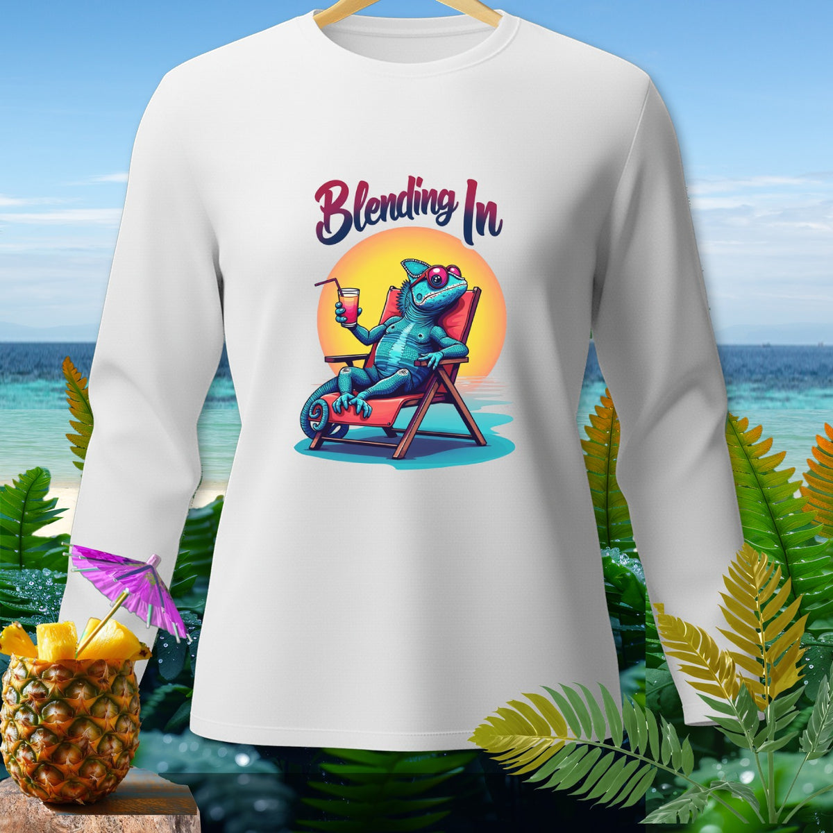 White long-sleeve shirt with a blue chameleon in a lounge chair holding a drink, text "Blending In".