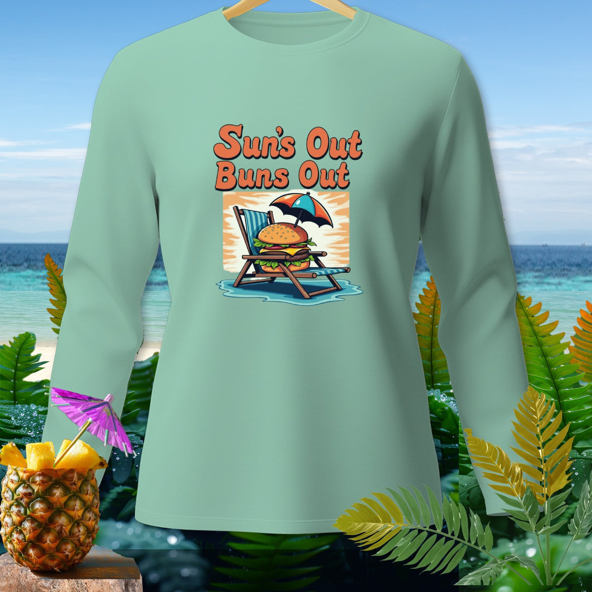 Mint long-sleeve shirt with "Sun's Out Buns Out" graphic of burger on beach chair.