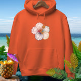 Orange hoodie with hibiscus ghost and pumpkin design on beach background.