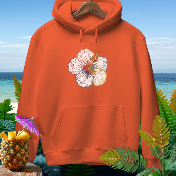 Orange hoodie with hibiscus ghost and pumpkin design on beach background.