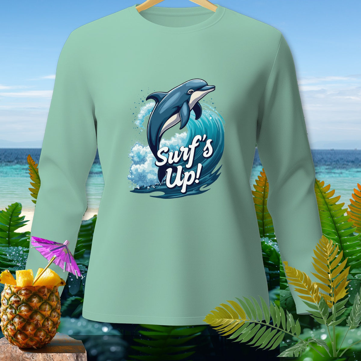 Light blue long-sleeve shirt with dolphin jumping on a wave, text "Surf's Up!".