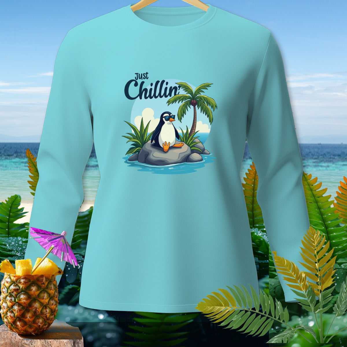 Long sleeve shirt with a cartoon penguin wearing sunglasses and the text "Just Chillin'".