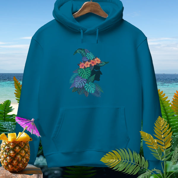 Teal hoodie with tropical floral witch hat silhouette graphic on a beach background.