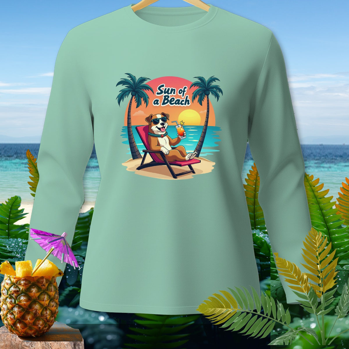 Light green long-sleeve shirt with a dog on a beach graphic saying "Sun of a Beach".