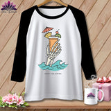 Raglan t-shirt with skeleton hand holding a cocktail, waves, and text 