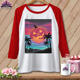 Raglan t-shirt with jack-o'-lantern at sunset on beach graphic.