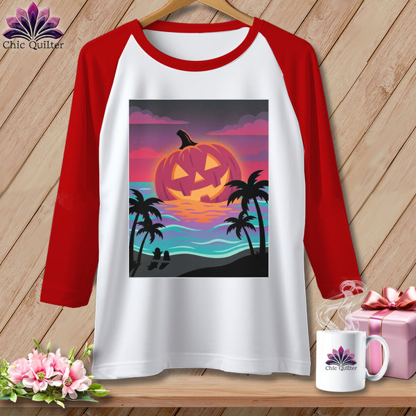 Raglan t-shirt with jack-o'-lantern at sunset on beach graphic.