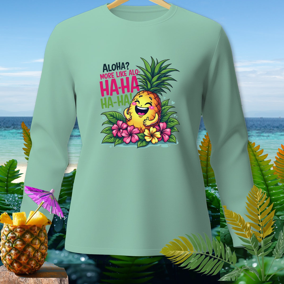 Mint long-sleeve shirt with a cartoon pineapple laughing and text "Aloha? More Like Alo-HA-HA HA-HA".