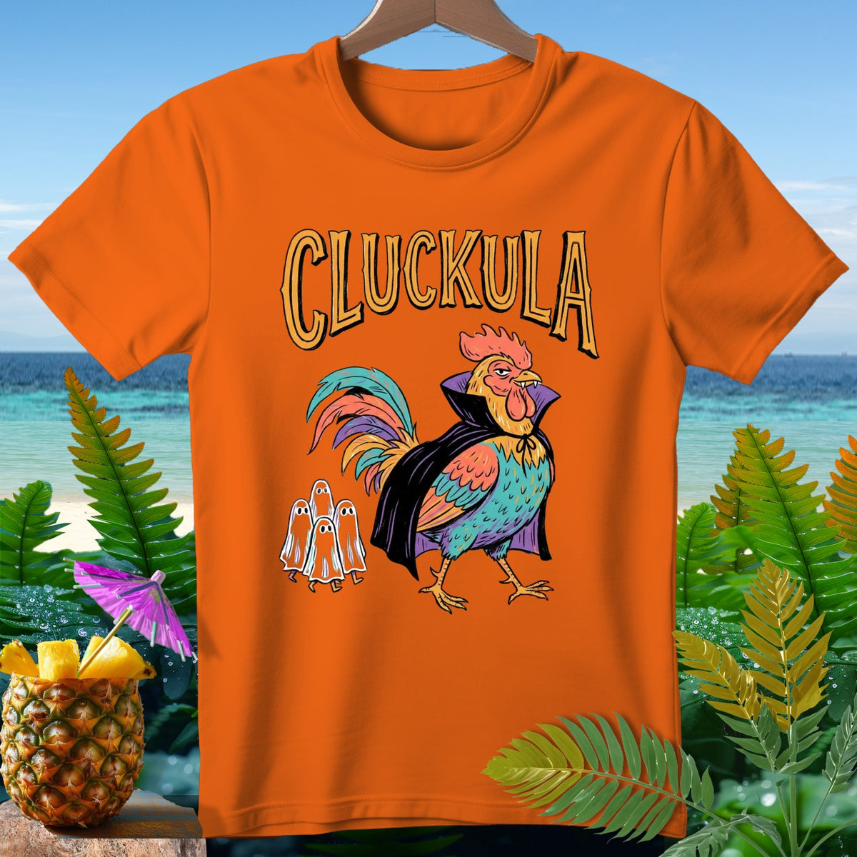 Orange t-shirt with "Cluckula" text and a vampire rooster with three ghosts.