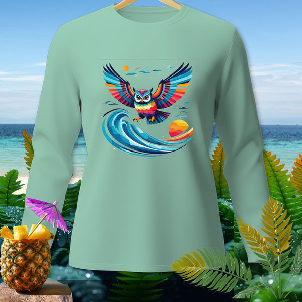 Mint green long-sleeve shirt with a colorful owl graphic above a wave and sunset.
