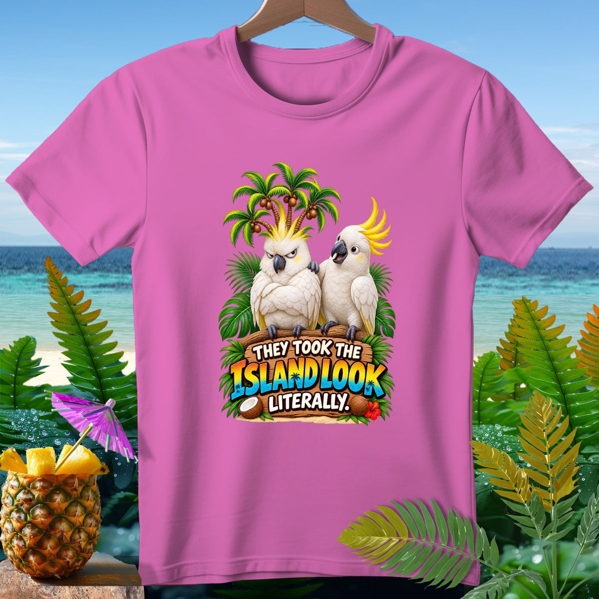 Pink t-shirt with two cockatoos and text "They took the island look literally."