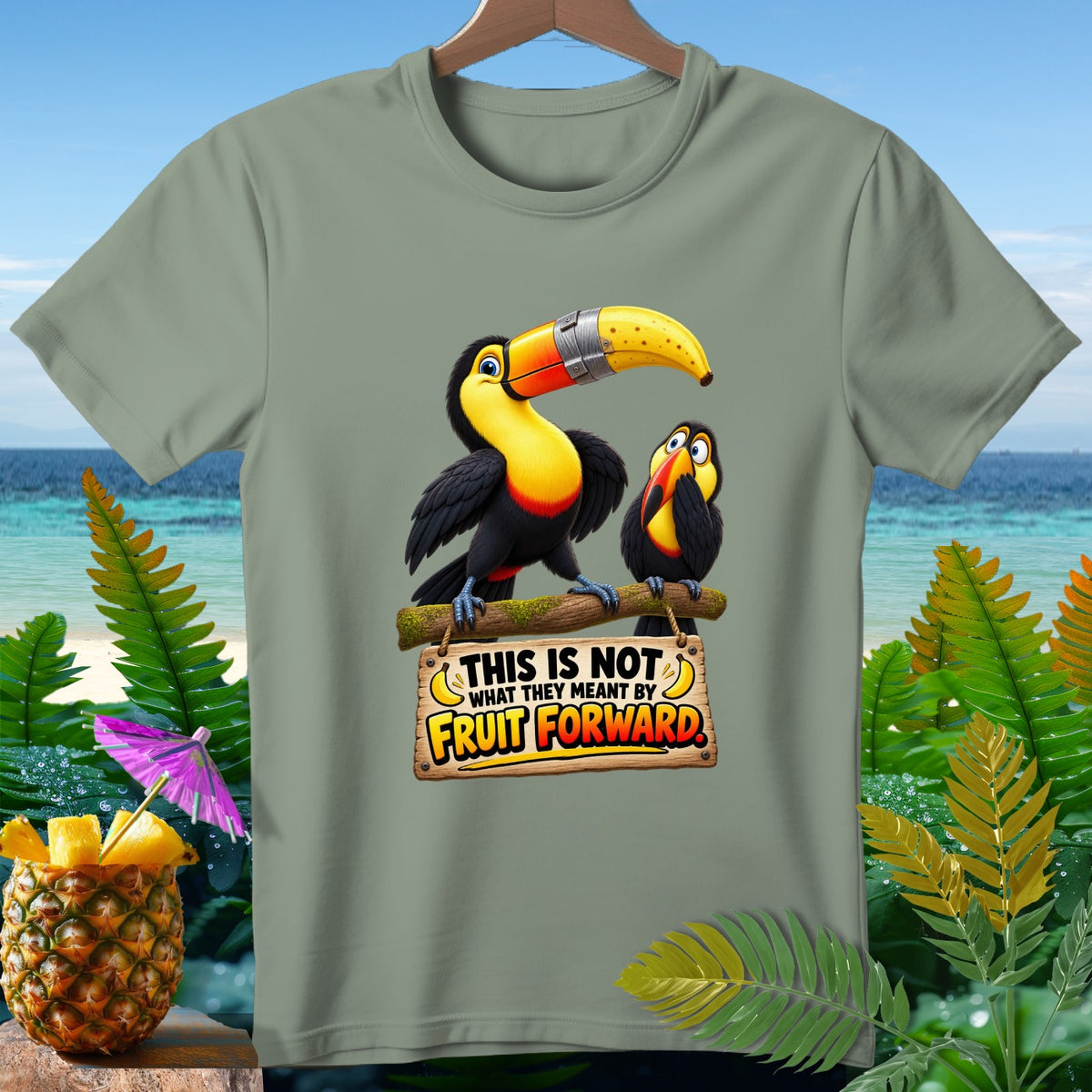 Two toucans on a branch, one with a banana in its beak, below a sign reading "THIS IS NOT WHAT THEY MEANT BY FRUIT FORWARD."