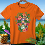 Orange t-shirt with a floral skull design and tropical background.
