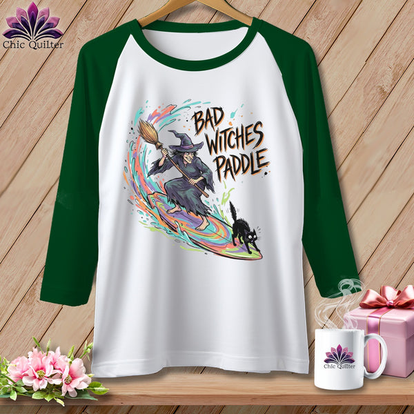 White raglan shirt with "Bad Witches Paddle" text, witch, and cat graphic.