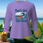 Purple long-sleeve shirt with an octopus surfing a wave, reads "Don't Get Tide Down."