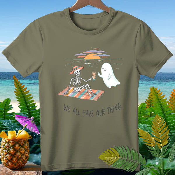 Skeleton and ghost on a beach blanket with text "We all have our thing."