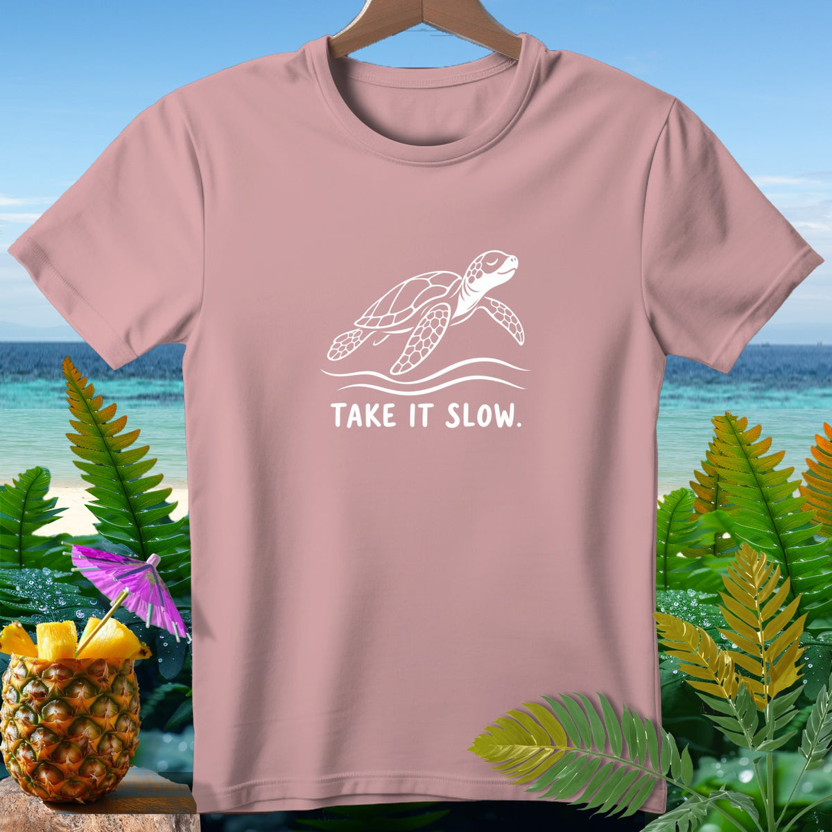 Pink t-shirt with a white sea turtle graphic and "TAKE IT SLOW." text.